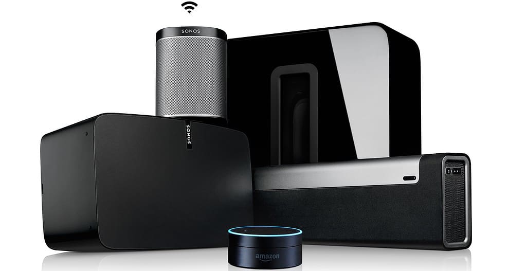pile of sonos speakers with Amazon Alexa Dot front and center