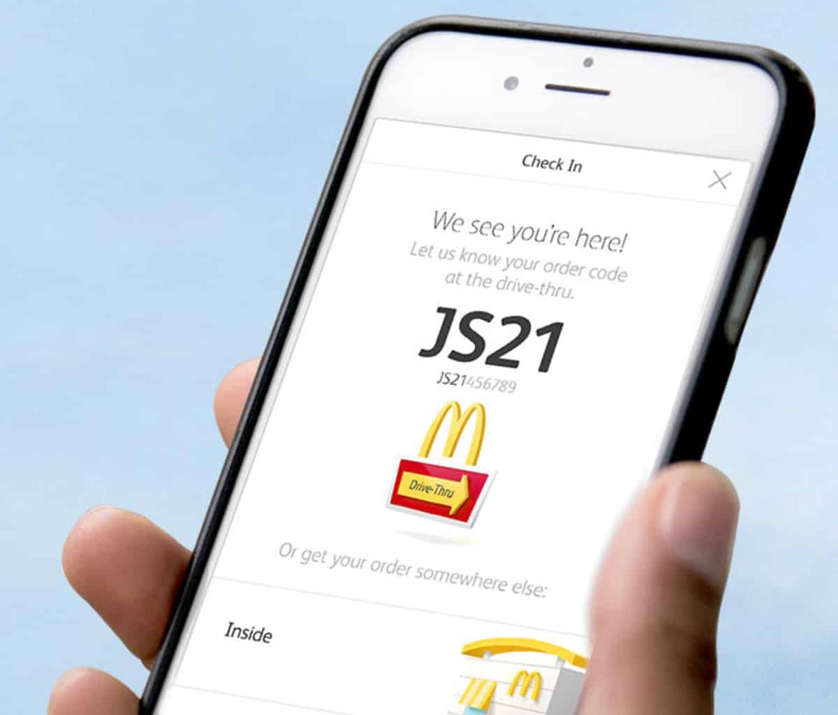 Someone holding an iPhone with McDonald's Mobile Ordering app