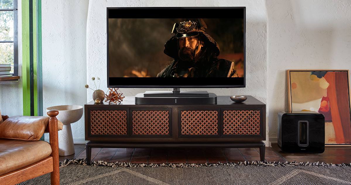 Black Sonos PLAYBASE underneath TV with movie playing