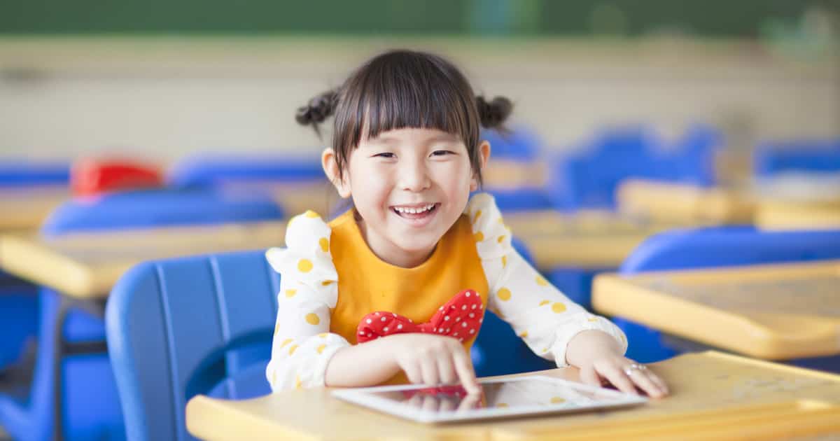 iPads in education - girl in classroom with an iPad