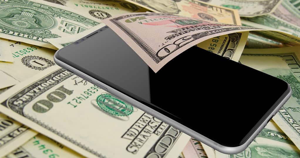iPhone X in a pile of money