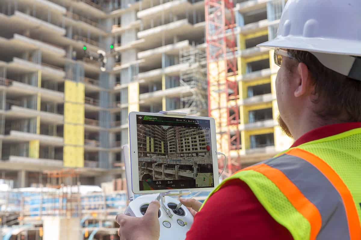 Technician using an iPad at a building site.