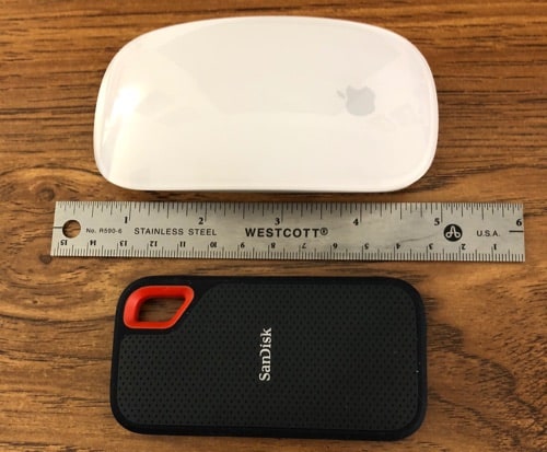 SanDisk Extreme Portable SSD next to ruler and Magic Mouse.