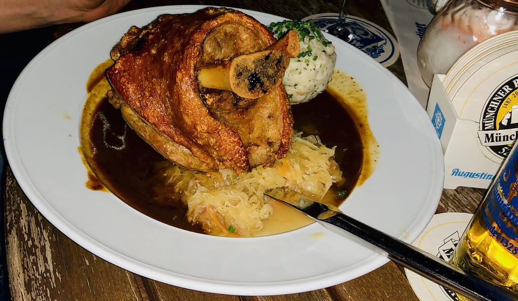 A pig's knuckle with sauerkraut is a German delicacy that tasted even better than it looks. 