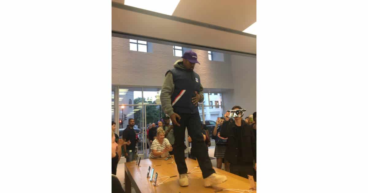 Kanye West walking on iPhone display table in Georgetown Apple Store