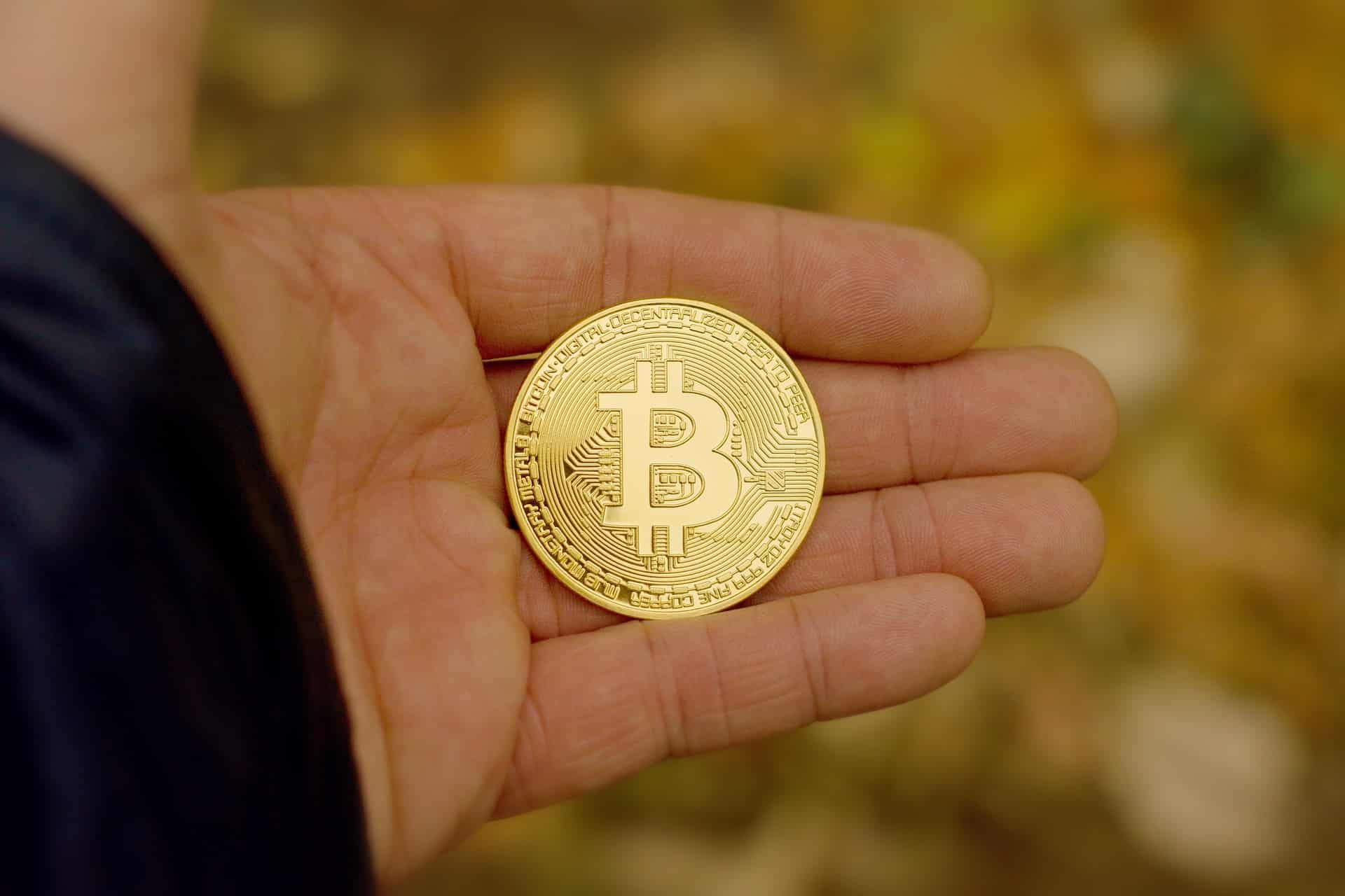 Physical bitcoin in someone's hand