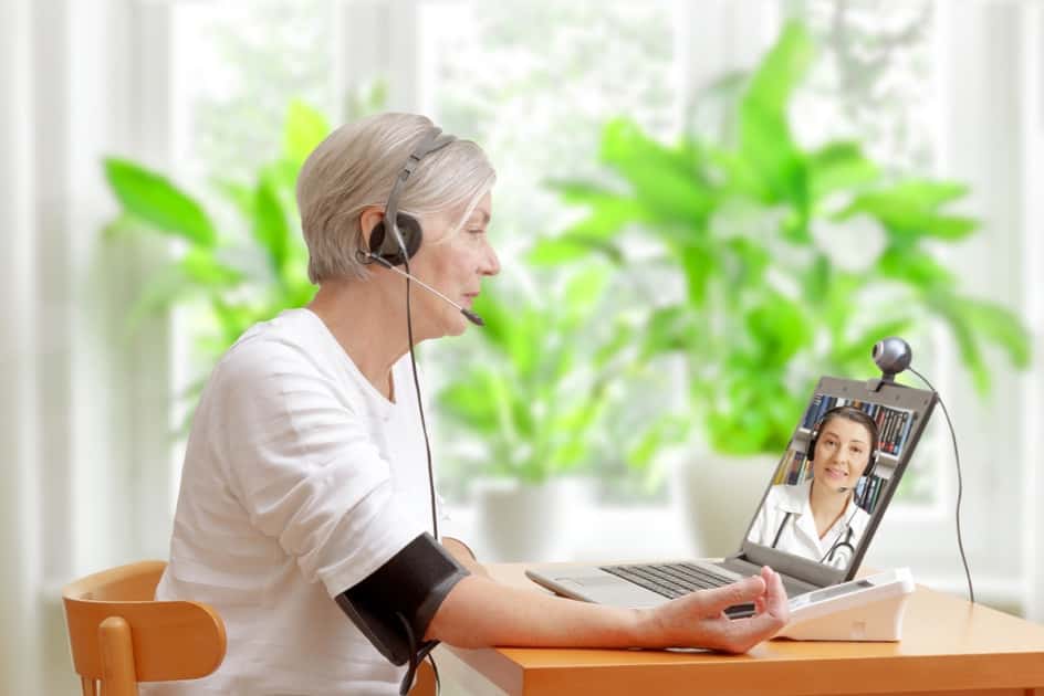 Woman consulting with doctor remotely.