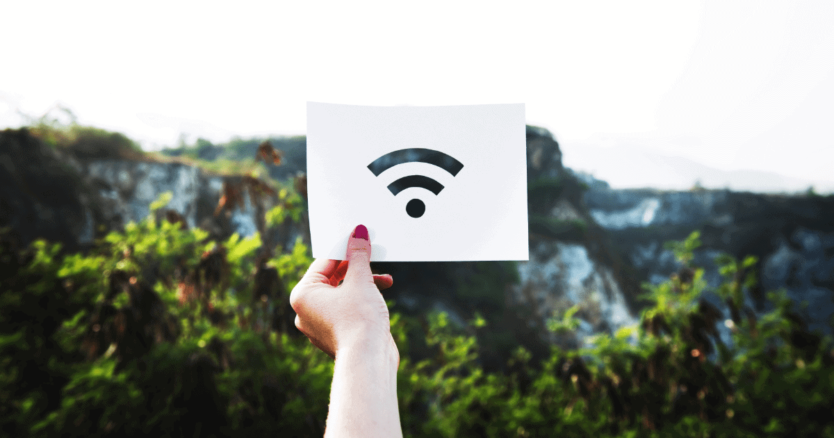 woman holding up a sign with the Wi-Fi symbol cut out of it.