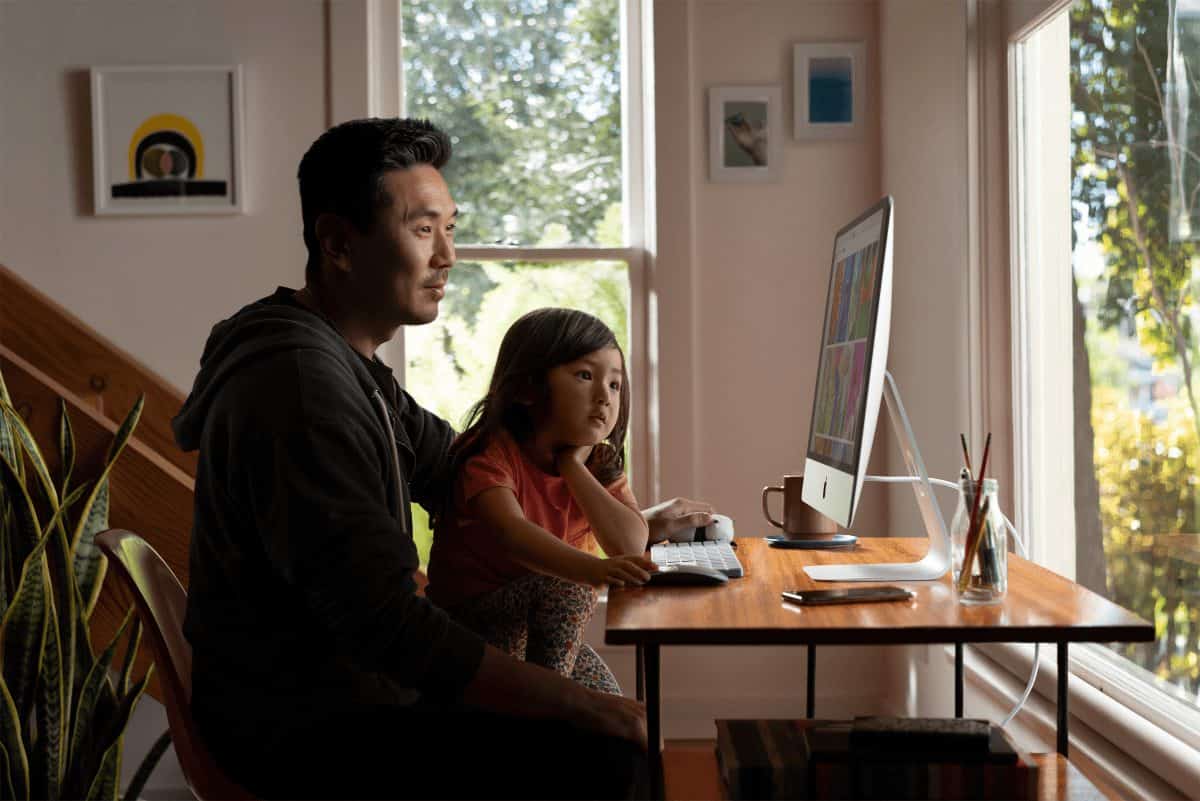 father and daughter using an imac