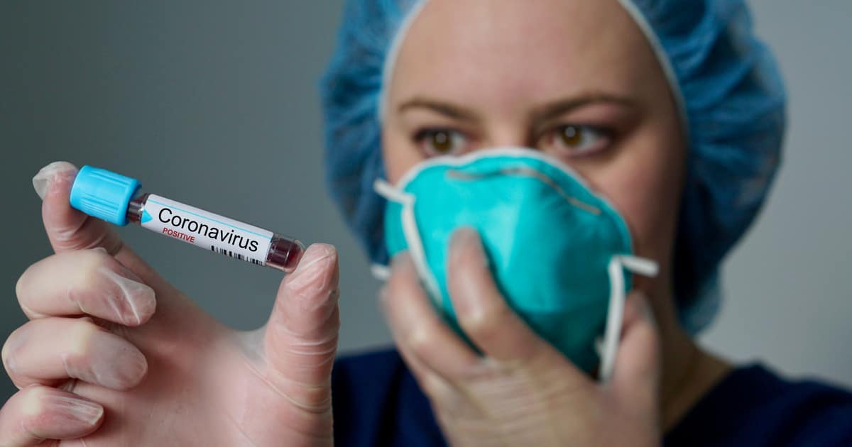 Masked nurse with Coronavirus vile