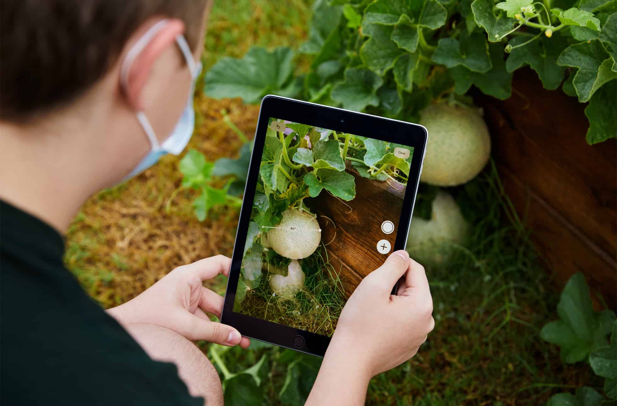 Coppell Middle School East eighth grader Stayton Slaughter uses the Measure app on iPad at the school’s community garden.