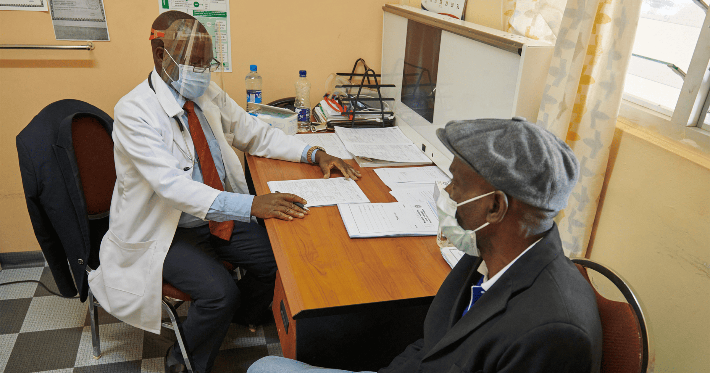 Doctor and patient using Apple PPE for COVID-19 at Zambia clinic