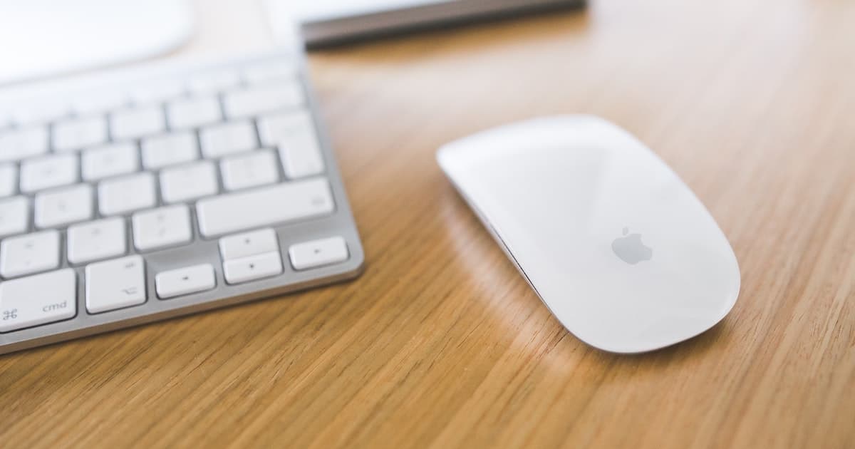 White Apple Magic Mouse Beside White Keyboard