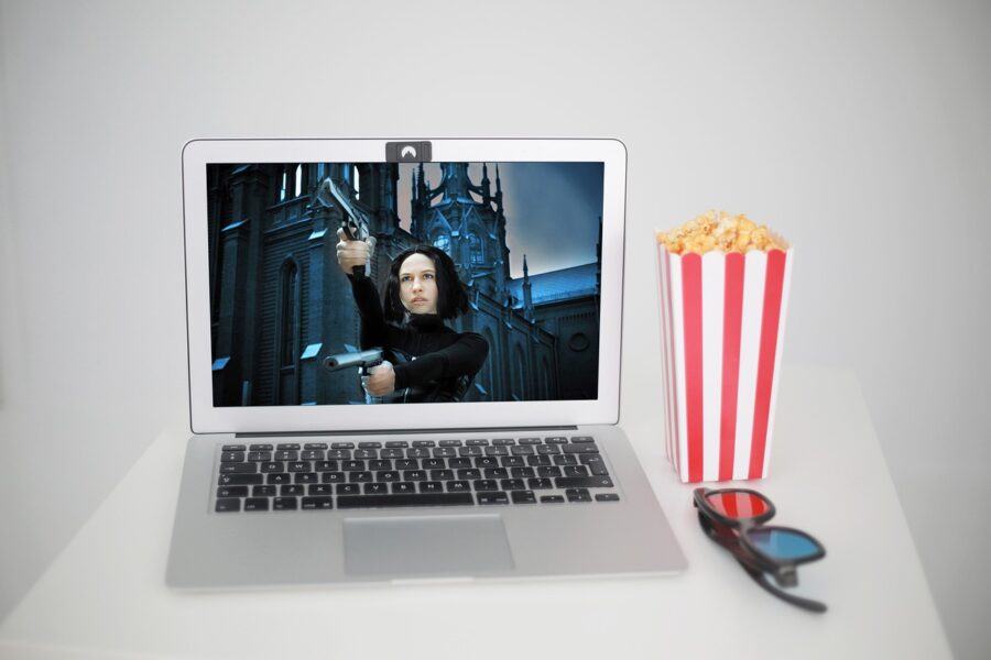 MacBook with popcorn, movie, and 3D glasses