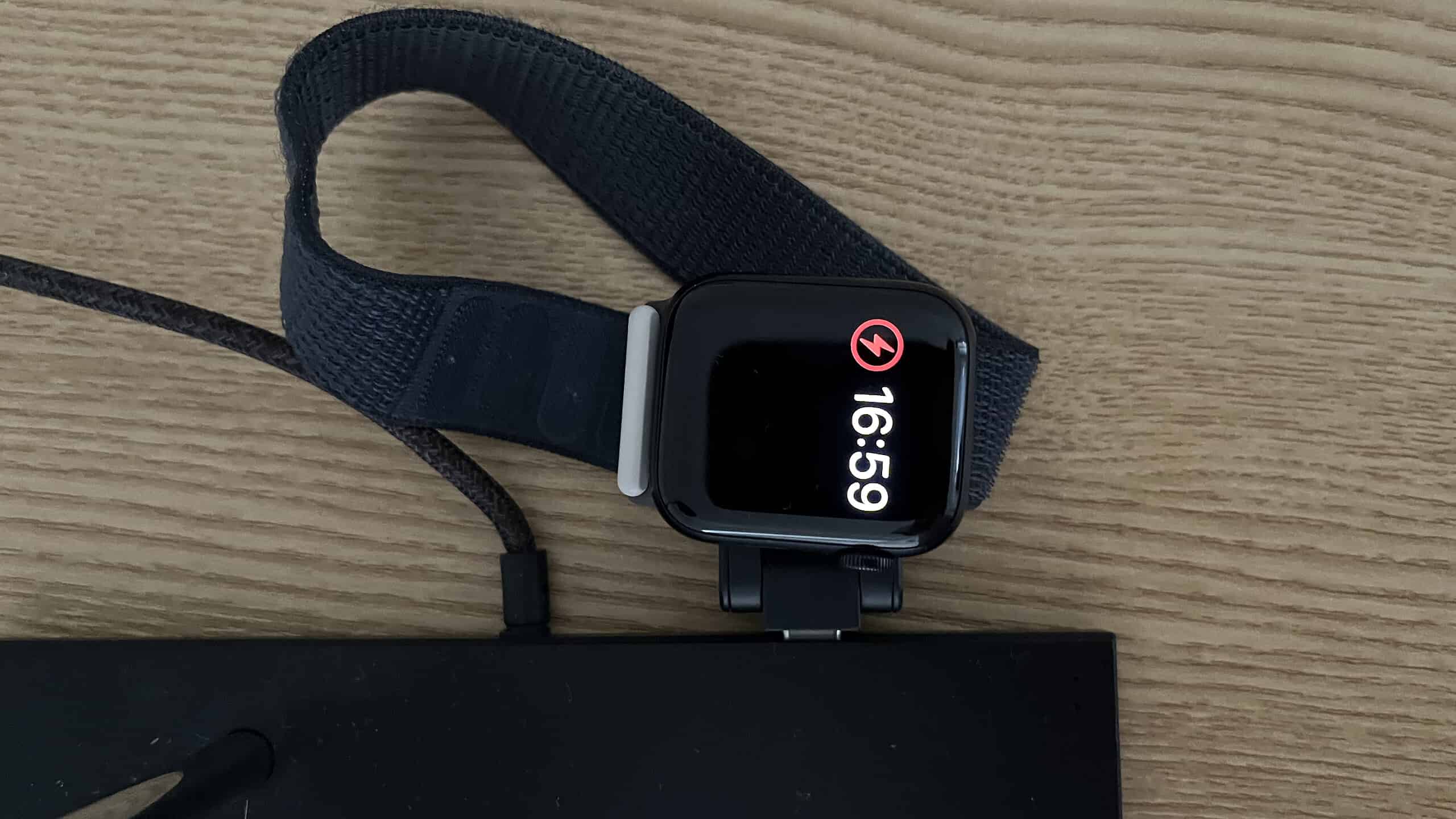 A photo showing an Apple Watch wirelessly charging