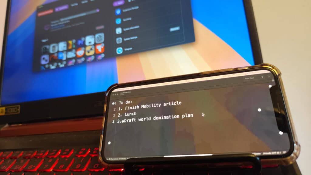 Mobility iPhone iPad stream deck app on the virtual display mode on an iPhone in front of a Hackintosh Acer laptop