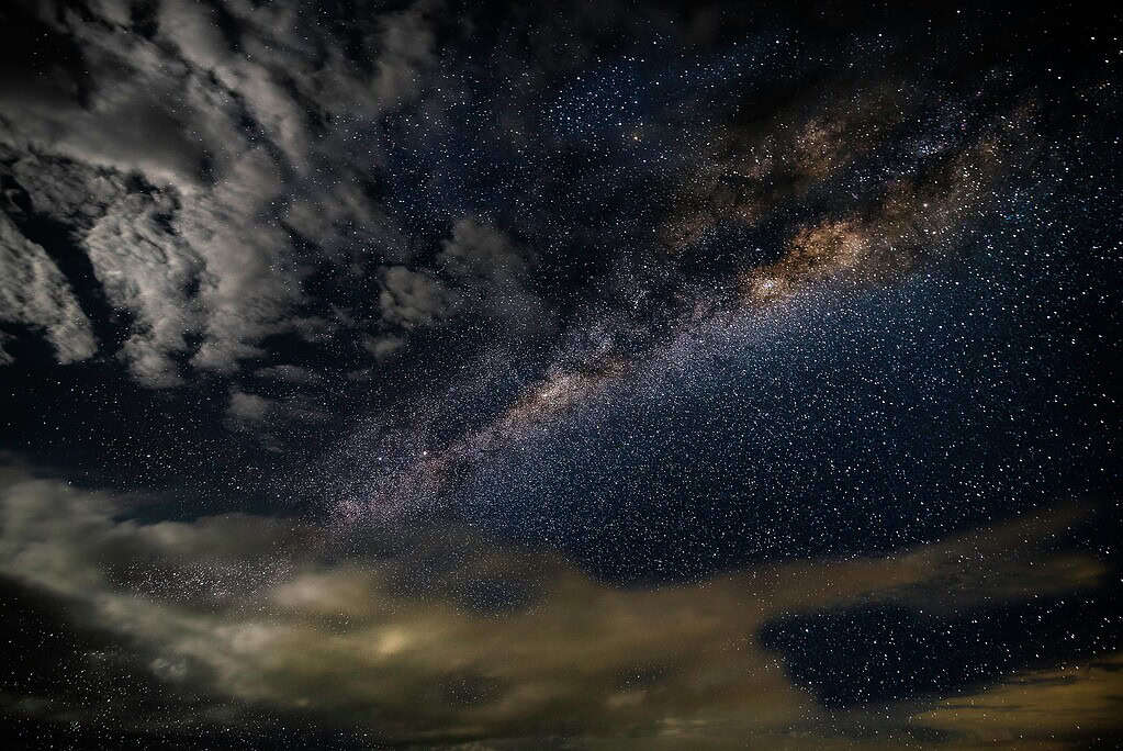 Stars and Clouds at Nighttime Wallpaper
