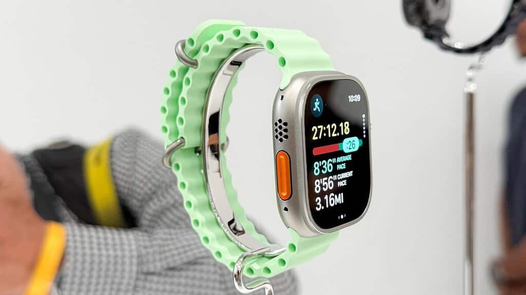 Apple Watch Ultra with mint perforated band displaying running stats: 27:12 elapsed time, 3.16 miles.