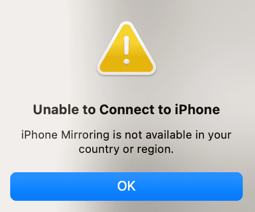 Close-up van macOS foutmelding: gele waarschuwingsdriehoek met tekst 'Kan geen verbinding maken met iPhone — iPhone-spiegeling is niet beschikbaar in jouw land of regio.'