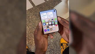 iPhone Duo held partly open during an outer-screen demonstration