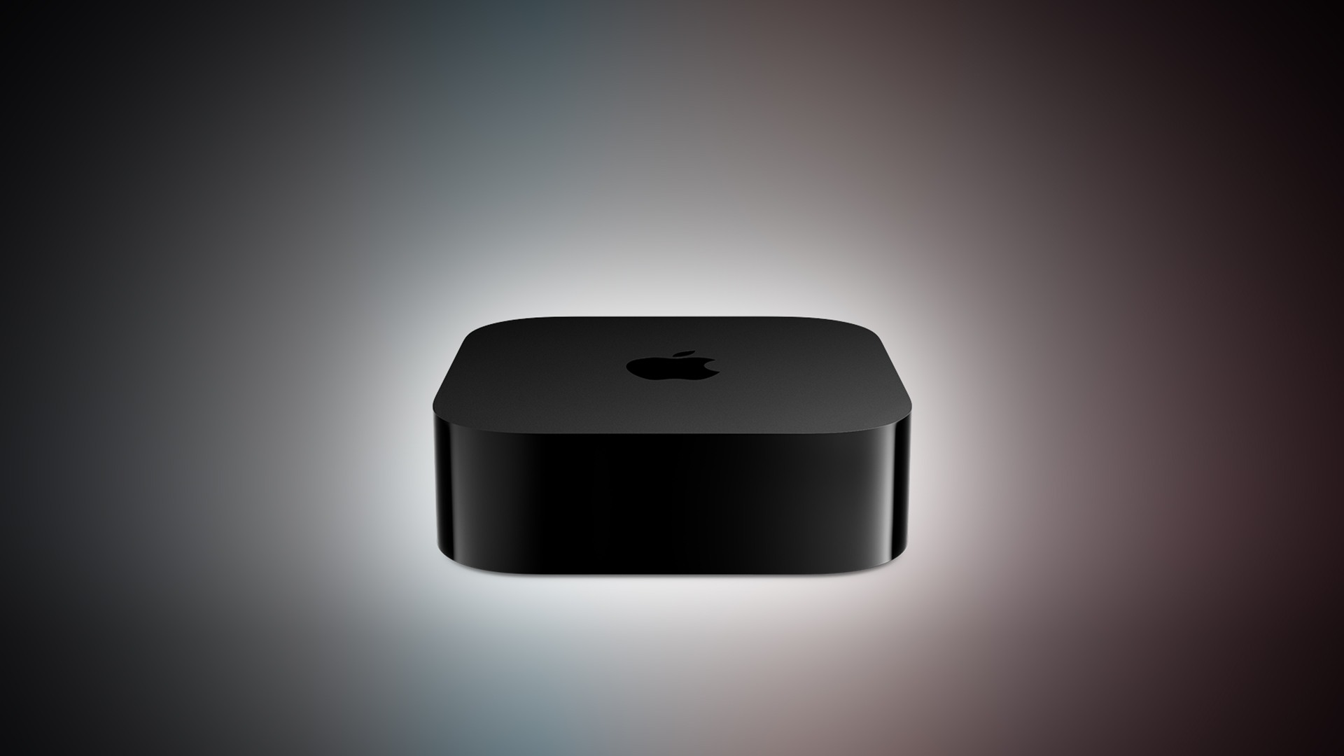 An unreleased black Apple TV 4K box shown on a colorful gradient