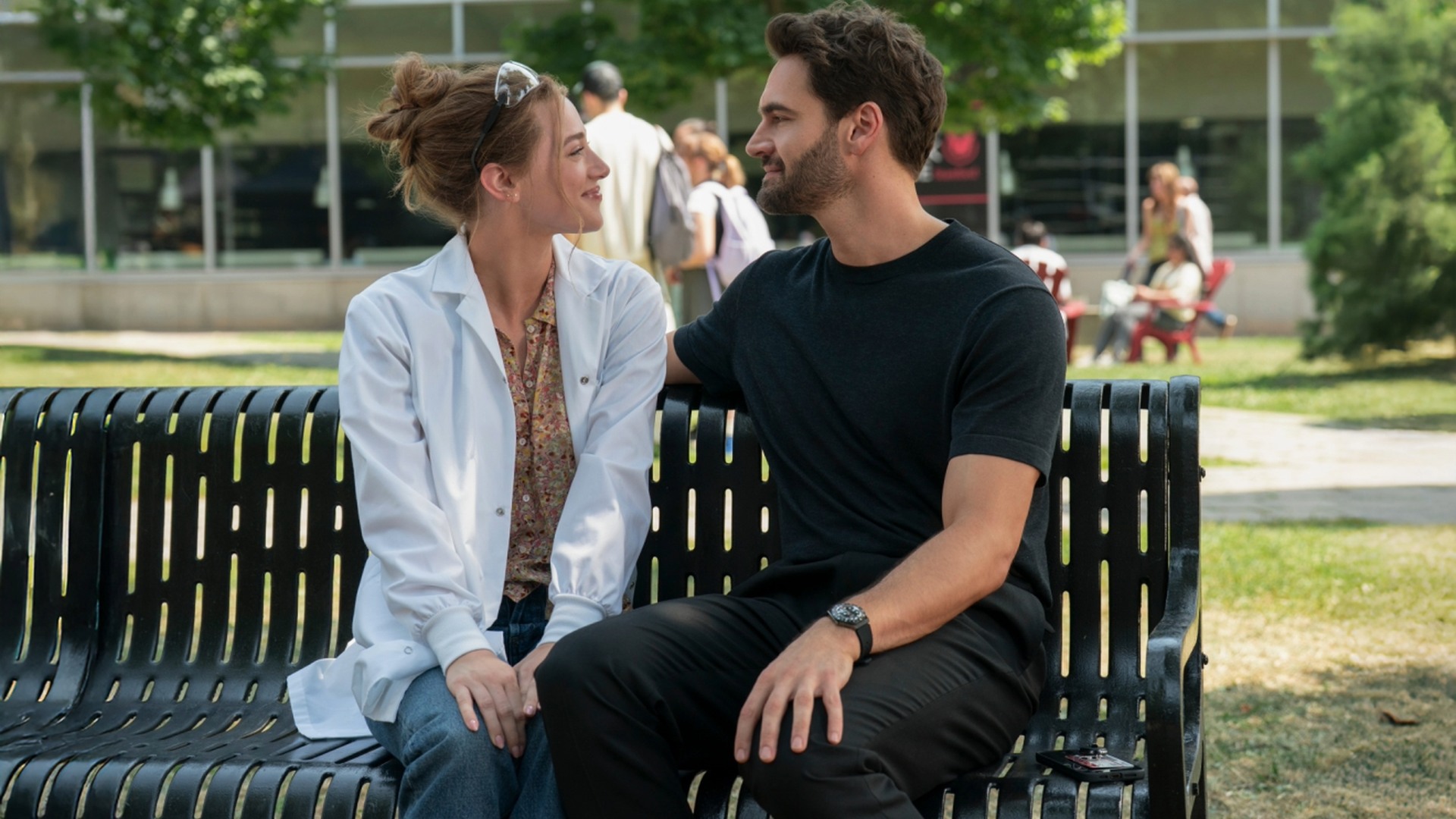 Olive and Adam sit together in The Love Hypothesis