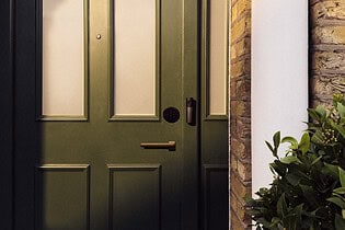 LG Smart Deadbolt Lock and Video Doorbell on a dark green front door