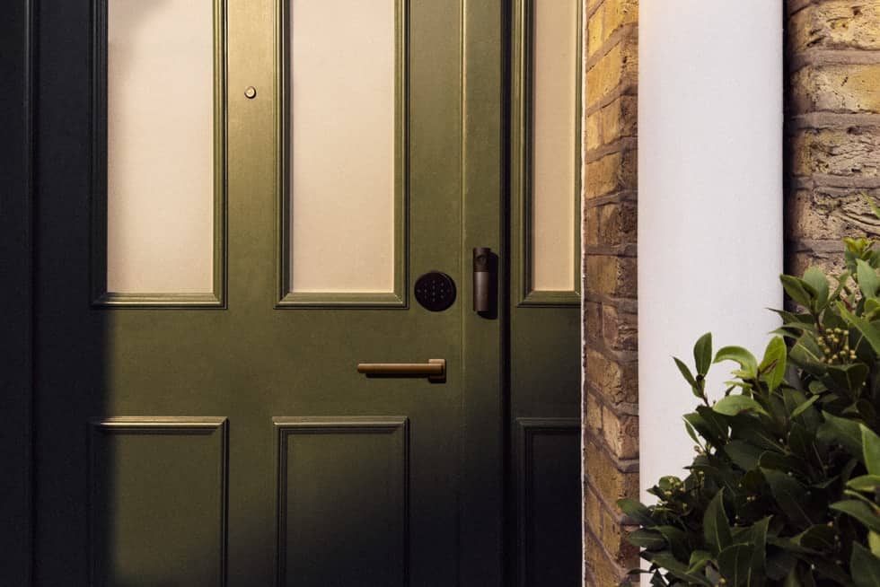 LG Smart Deadbolt Lock and Video Doorbell on a dark green front door