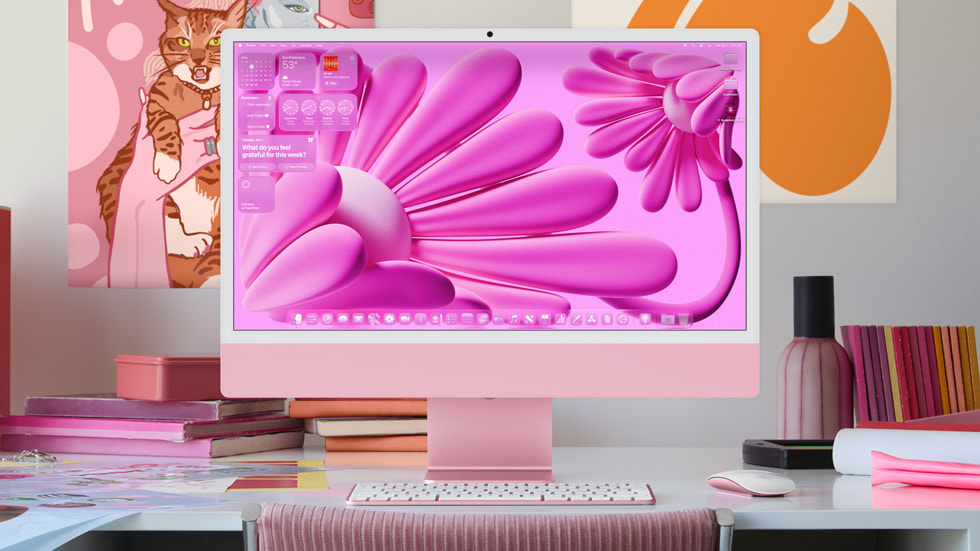 Pink iMac on a desk running macOS