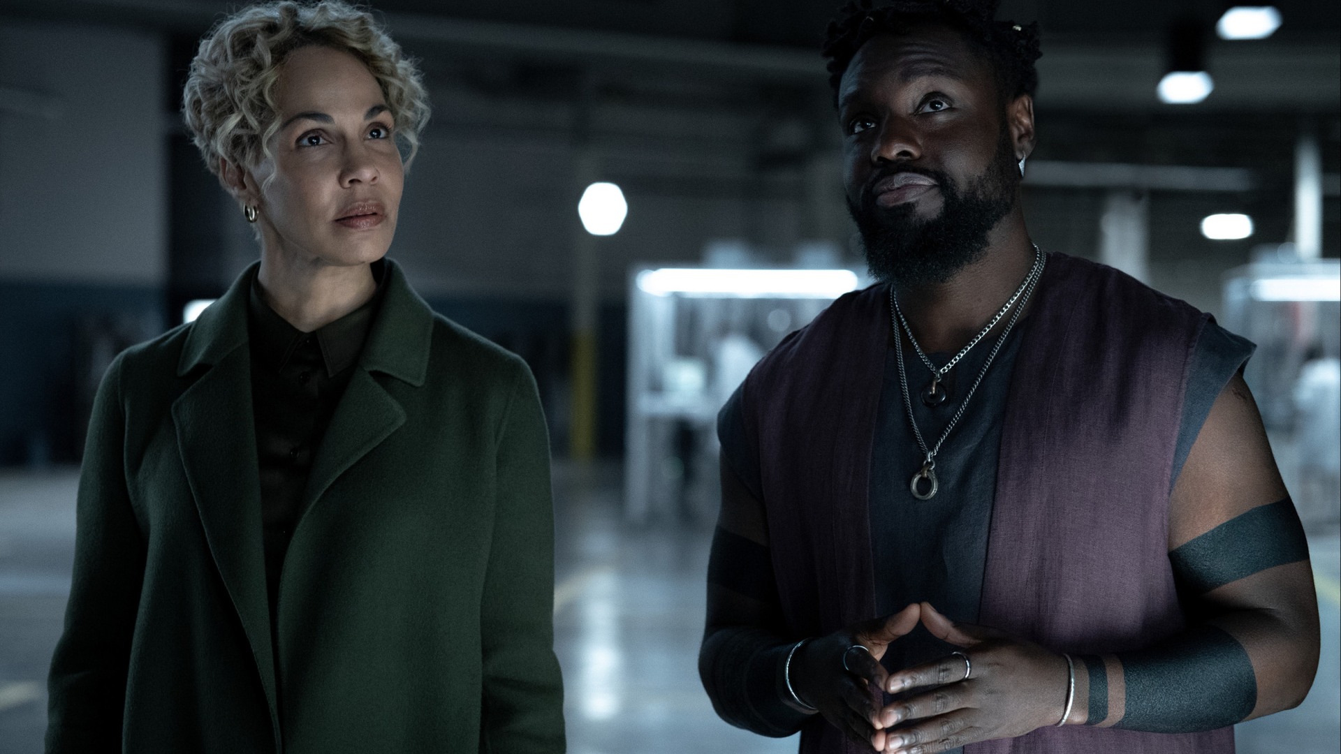 Blair Caplan and Leighton Vance look upward inside an industrial space in Dark Matter Season 2