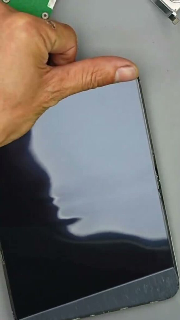 Wavy reflected light on a display as its surface film is peeled back