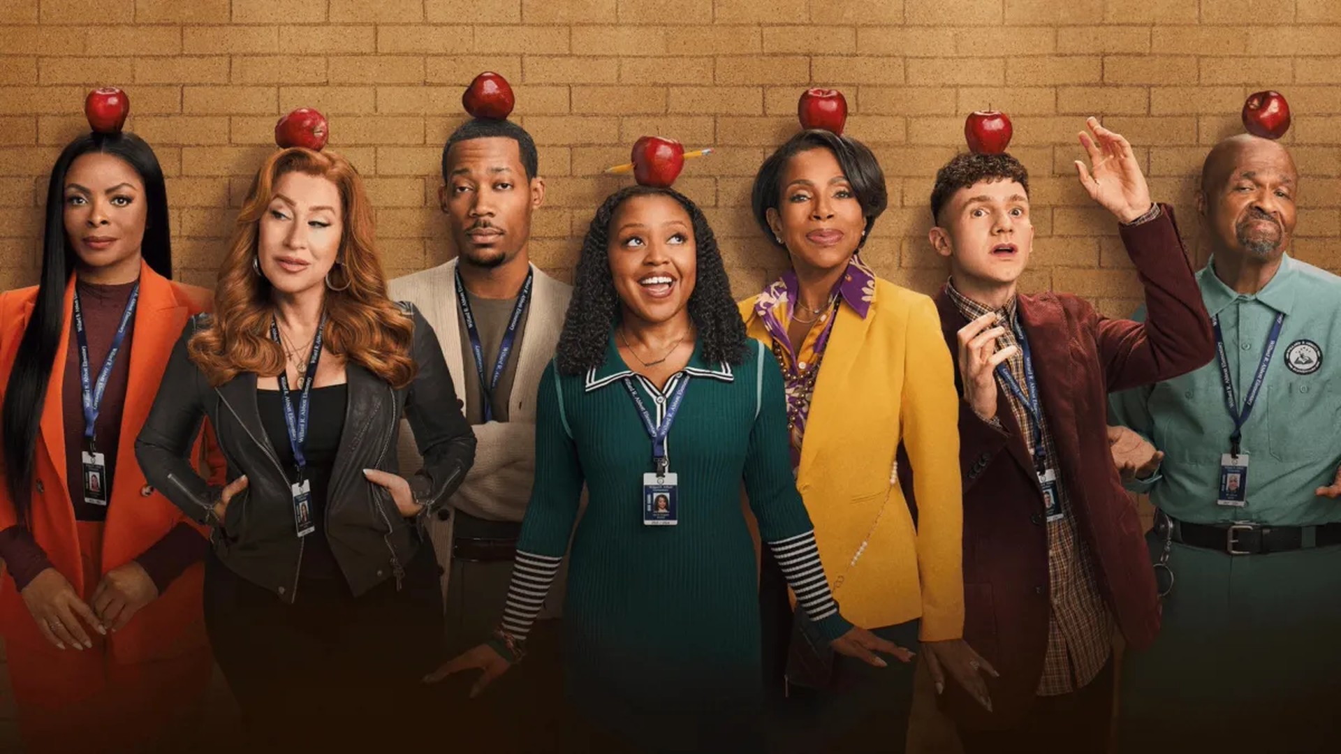 The Abbott Elementary staff pose with red apples for Season 6