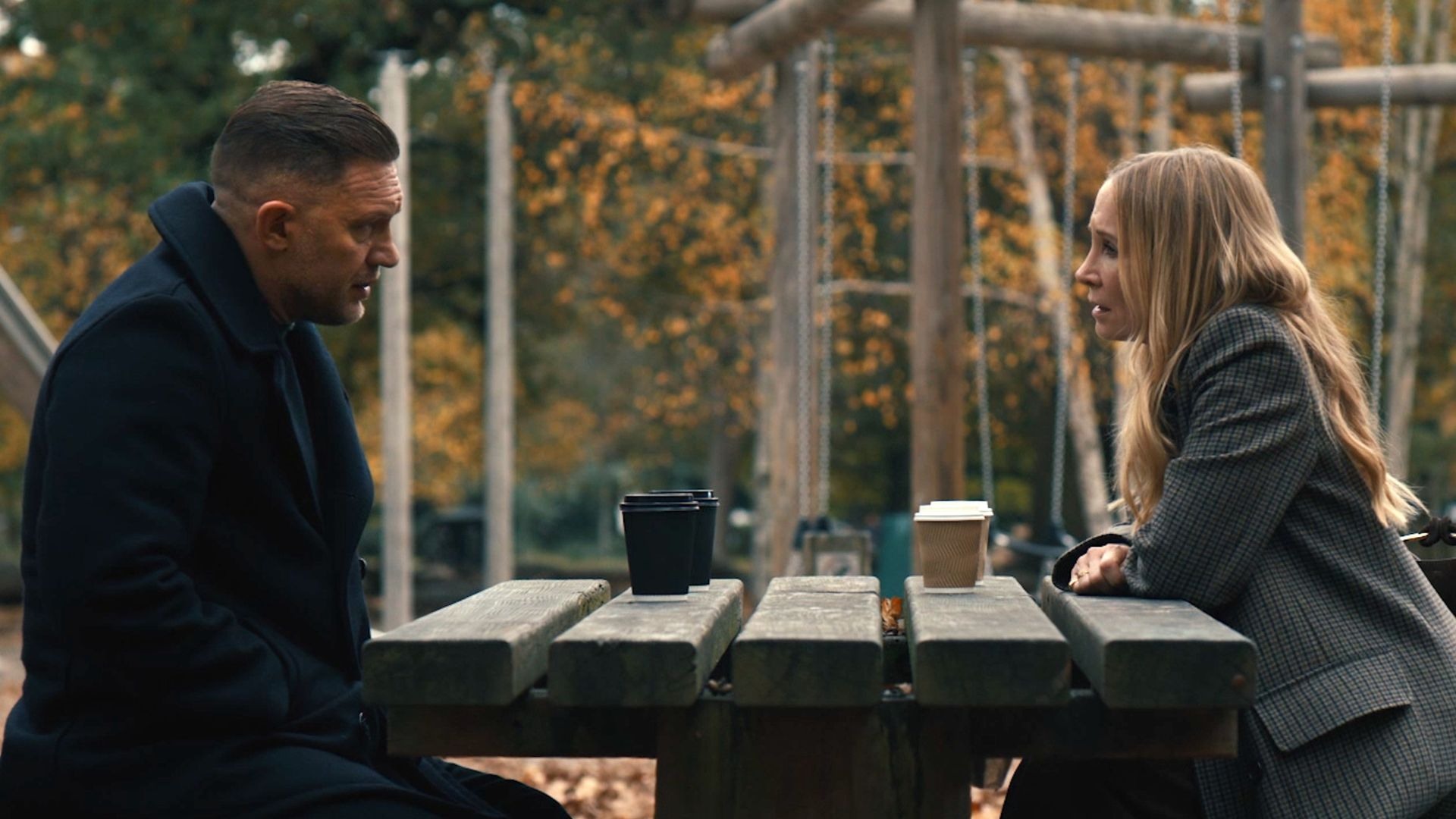 Harry and Jan Da Souza speak across a picnic table in MobLand Season 2